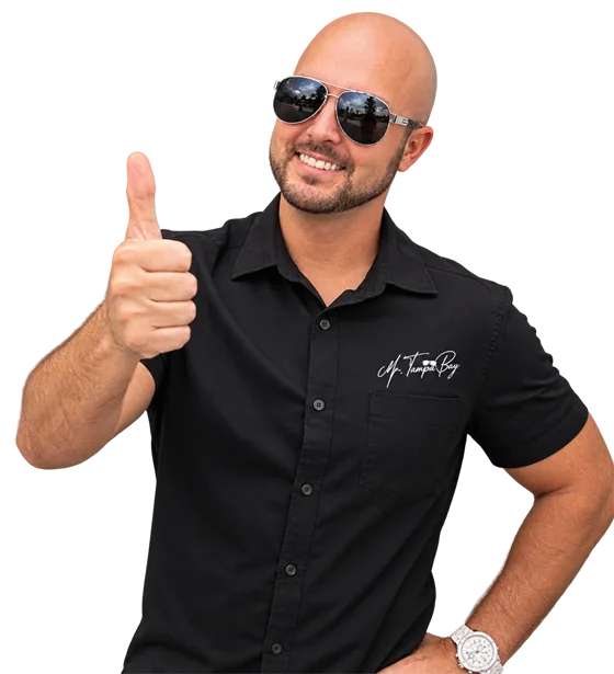 Mr. Tampa Bay giving a thumbs up in his black Mr. Tampa Bay shirt and aviator sunglasses