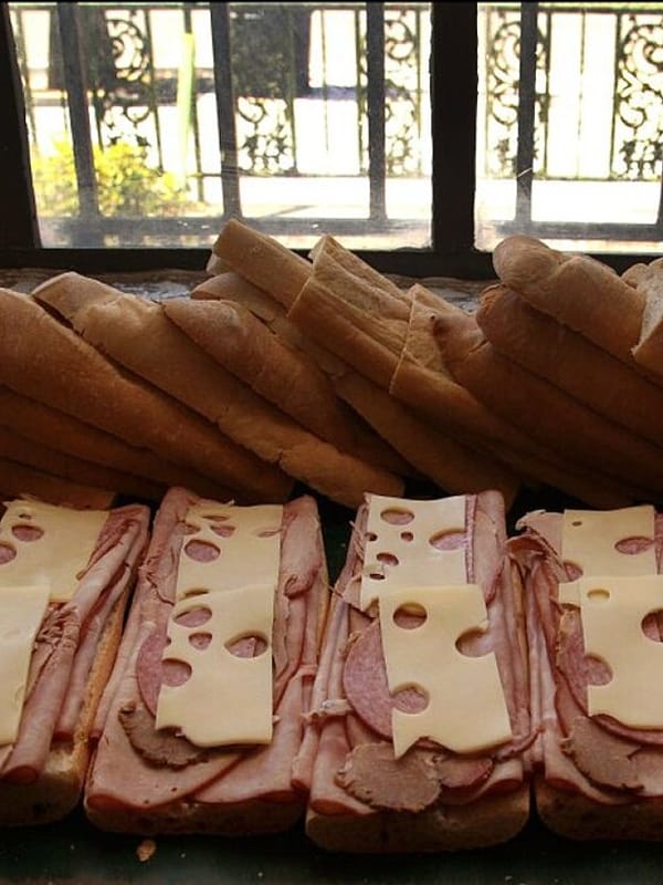 A row of Cuban sandwiches being made on La Segunda bread in Ybor City